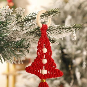 Detail view of handmade red macrame Christmas tree wall hanging with white wooden beads