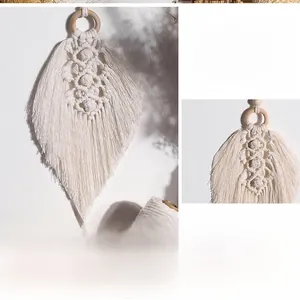 Detailed view of hand-woven macrame wall hanging with ivory cotton leaves and wood ring