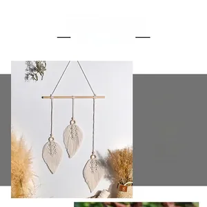 Detailed macro view of handmade leaf-shaped woven cotton tapestry with natural wooden pole