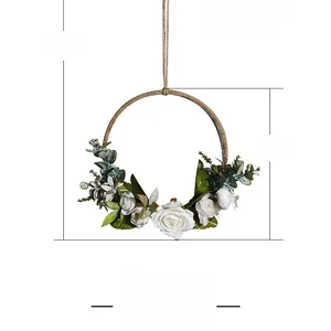 Detail view of artificial rose and eucalyptus floral wreath on rustic hemp rope metal ring