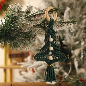 Detail of handcrafted green macrame Christmas tree with wooden beads and a hanging ring