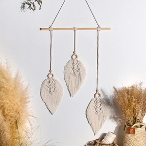 Bohemian hand-woven cotton macrame wall hanging with three cream leaf-shaped tassels