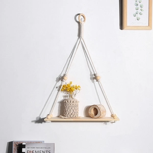 Detail view of Bohemian wall shelf with hand-woven cotton ropes and natural wood beads