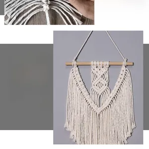 Detailed view of hand-woven bohemian cotton tapestry with intricate knots and long fringe
