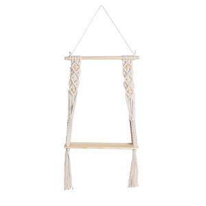 Detailed view of handmade macrame weaving patterns and wooden beads on the wall shelf