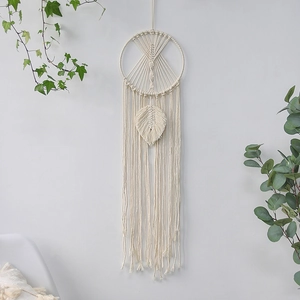 Handmade macrame wall hanging with owl moon dreamcatcher design in boho style