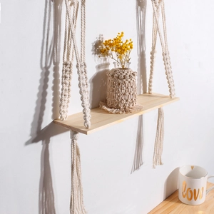 Boho woven wall hanging shelf with natural wood board and cream tassel rope decor