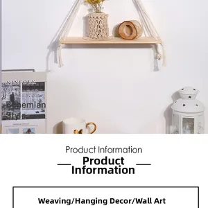 Detail of bohemian handmade woven wall shelf with white cotton tassels and wood board