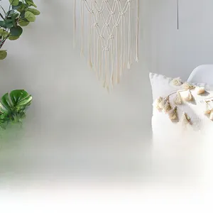 Detailed view of bohemian style handmade cotton weave tapestry with fringe wall decor