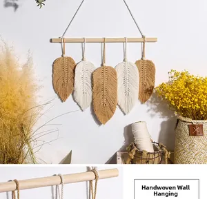 Detailed close-up of handmade bohemian woven leaf wall hanging with natural cotton rope