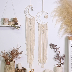 Detail of bohemian moon macrame wall hanging with woven cotton fringe and beads