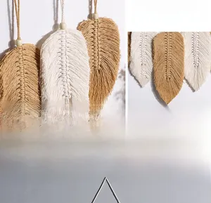 Close-up of bohemian leaf-shaped hand-woven cotton wall hanging with wooden beads