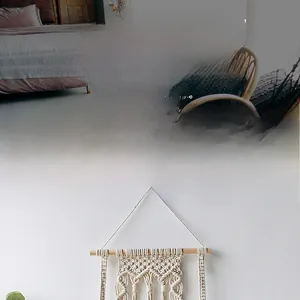 Close-up of handmade macrame wall hanging with cotton weaving and wooden shelf detail