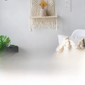 Detail of bohemian hand-woven cotton tapestry wall hanging with wooden storage shelf