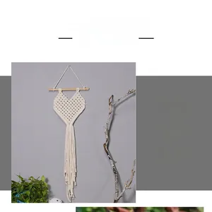 Close-up of handmade heart-shaped cotton macrame wall hanging with long tassels