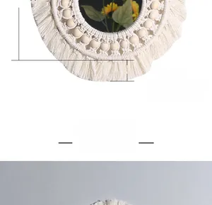 Detailed close-up of macrame wall mirror with cotton tassels and wooden beads