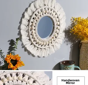 Detailed close-up of handmade macrame fringe and wooden beads on a boho wall mirror