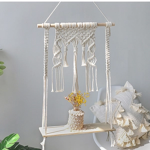 Detail of hand-woven bohemian tapestry shelf showing macrame patterns and wooden textures
