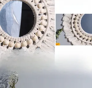 Detail of bohemian woven macrame wall mirror with decorative wooden beads and fringe