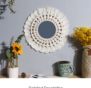 Close-up of Bohemian woven macrame mirror with cotton tassels and wooden beads detail
