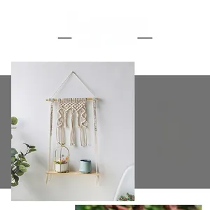 Detail of bohemian handmade woven wall shelf with macrame cotton rope and wooden board