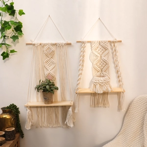 Handmade macrame wall hanging shelves with wooden boards in bohemian style for home decor