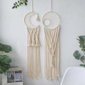Detailed close-up of bohemian hand-woven crescent moon and sun dreamcatchers with tassels