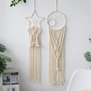 Detailed macro of woven cotton star and moon macrame wall hanging with long tassels