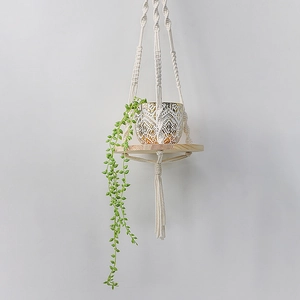 Handmade macrame plant hanger with wooden shelf and ivory cotton rope for wall decor
