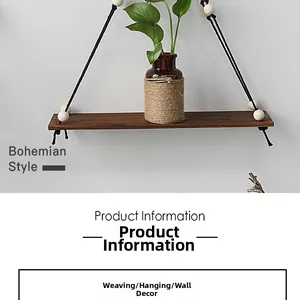Detail of bohemian handmade wooden wall shelf with black woven rope and white beads