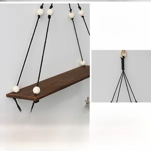 Detail of hand-woven macrame wall shelf with dark wood board and decorative beads