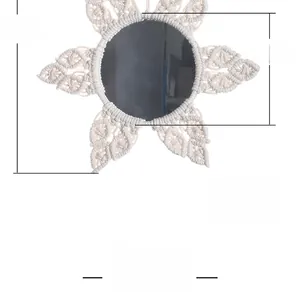Detail of hand-woven flower wall mirror with 32cm diameter and boho tassel style
