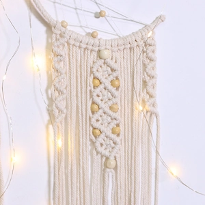 Detail of bohemian moon dream catcher with handmade woven cotton rope and wooden beads