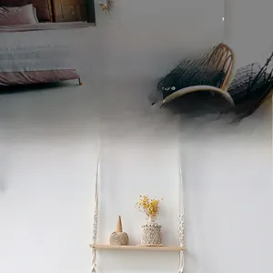 Close-up of handmade macrame wall shelf with cotton rope weaving and natural wooden board