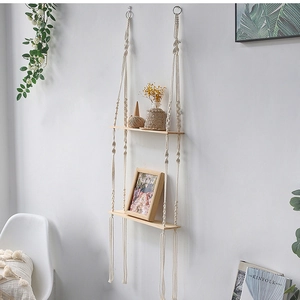 Detail of bohemian two-tier wooden hanging shelf with handmade cotton rope weaving