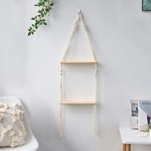 Detail of double-tier macrame wall shelf with cotton rope and light wood boards