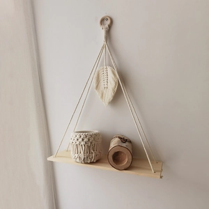 Handmade boho macrame wall shelf with woven leaves and wooden shelf for home decor