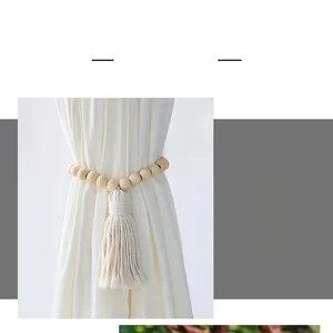 Close-up of wooden bead curtain tieback with natural cotton fringe tassel on white curtain