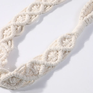 Detail of bohemian ivory cotton rope curtain tieback with handcrafted weaving