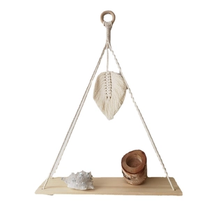 Handmade macrame wall hanging shelf with woven leaves and wooden swing display board