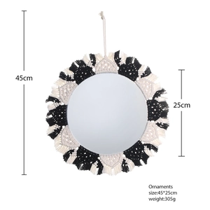 Macro detail of Bohemian woven wall mirror with black and white cotton fringe and size info
