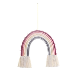 Close-up of handmade woven rainbow wall hanging with soft pom poms and long tassels