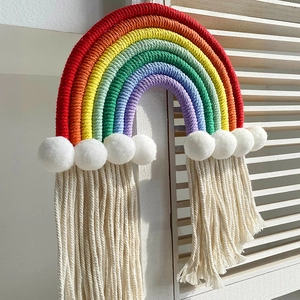 Handmade bohemian rainbow wall hanging with colorful cotton ropes and white tassels