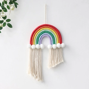 Handmade bohemian rainbow wall hanging with six-color cotton rope and white pom-poms