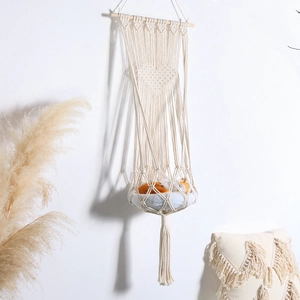 Detailed view of bohemian woven cat bed with heart pattern and elegant fringe tassels