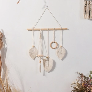 Detailed macro view of bohemian hand-woven macrame wall hanging with wooden beads and tassels