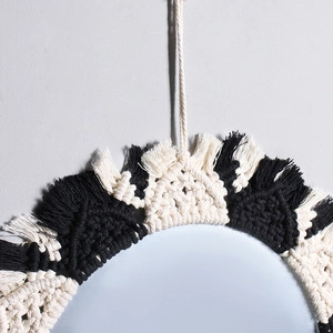 Detail of handcrafted bohemian cotton rope weave with black and white fringe accents