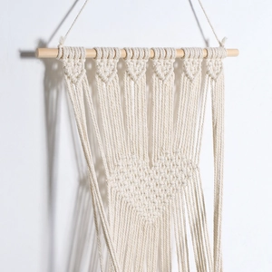 Handwoven bohemian macrame cat bed swing with heart pattern and natural wooden rod
