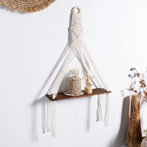 Detailed macro view of the boho woven cotton rope patterns on the wooden wall shelf