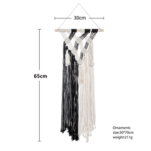 Bohemian style hand-woven black and white geometric wall hanging with cotton tassels
